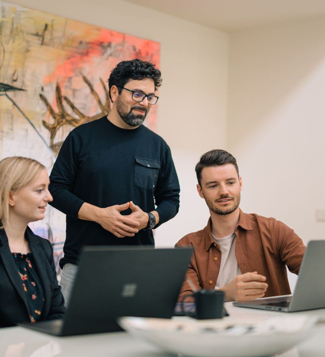 Three people working together on a project - change management consulting from SUNZINET